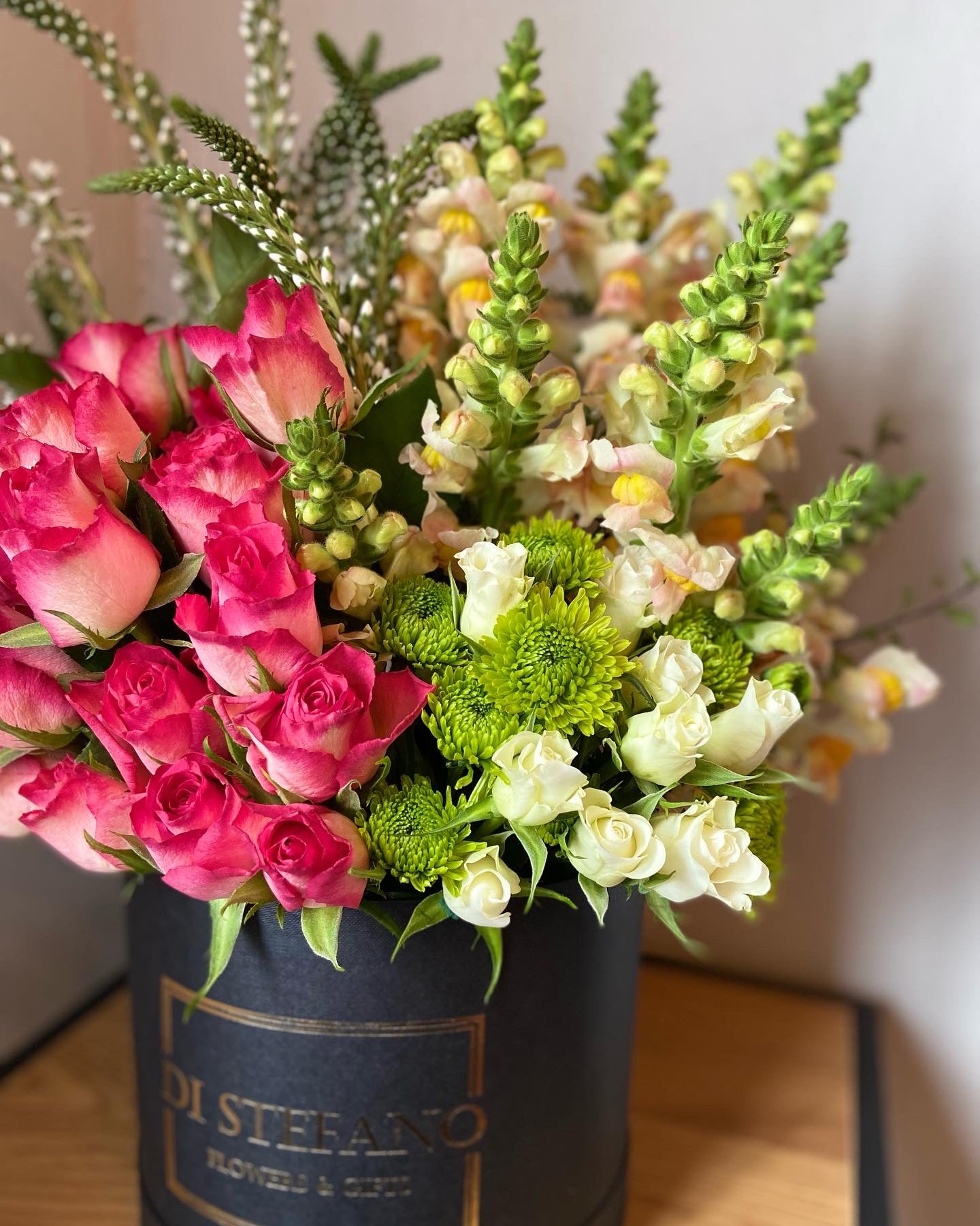 Pink cascade floral arrangement in large hatbox