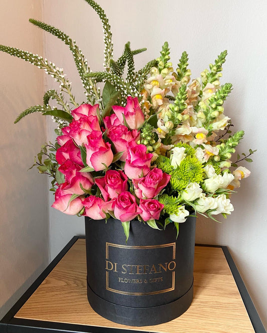 Pink cascade floral arrangement in large hatbox